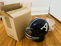 Helmet radio beside open cardboard box