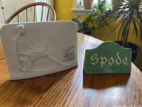 Both dealer display signs side by side on table