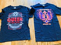 Front view of both T-shirts laid flat on floor