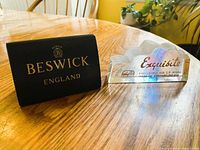 Both dealer display signs side by side on table