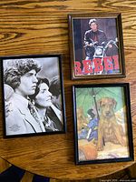 All three framed prints displayed on table