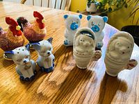 All four pairs of animal ceramic shakers on table