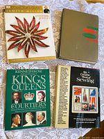 Four books laid out on lace cloth showing covers