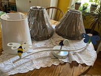 Lot overview: three shades visible, white shade foreground, two brown dragonfly shades, insect ceiling fixture