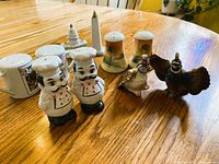 All five shaker pairs grouped on table: chefs, playing cards, Washington DC monuments, Nippon landscape, pheasants