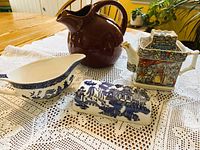 All four ceramic items together on lace cloth
