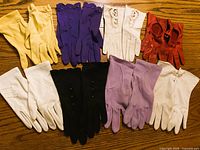 All eight glove pairs laid out by color