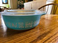 Side view showing turquoise casserole and pattern