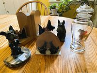Group shot showing all Scottie dog items including oak bookends, glass decanter, inkwell, figurines