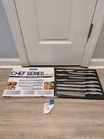 Outer box with Chef Series Deluxe branding beside open tray showing 10 stainless pieces