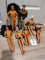 All seven figures arranged on floor against door