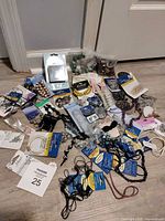 Overview of entire assortment of beads, findings, cords, packaged items scattered on floor