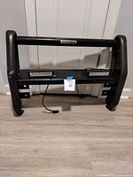 Front view of black Go Rhino grille guard with attached LED lights