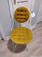 Full view of chair front showing wrought iron frame and velvet upholstery