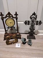 Overall lot showing clock, cross, bookends, candle holders