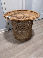 Full view showing wicker side table with peacock motif top