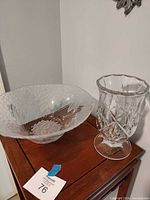 Large clear pressed glass bowl and crystal vase on wooden surface