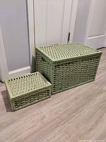 Large and small green rattan baskets side by side closed