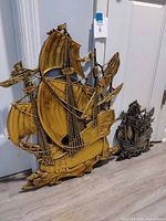 Front view of both ship plaques showing relative sizes and finishes