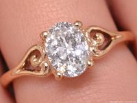 Ring on finger showing diamond and scroll design