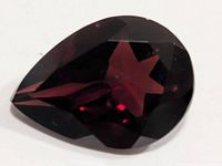 Pear-cut deep red garnet front view