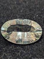 Top view of oval green amethyst showing facets and color