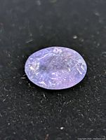Oval violet-blue tanzanite loose stone on dark background