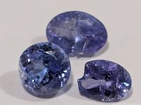 Three damaged oval tanzanite stones