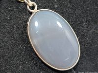 Front view of oval chalcedony pendant in silver setting