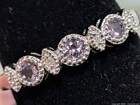 Front view of sterling silver ring showing amethyst and white accent stones