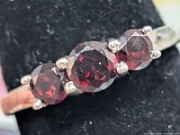 Close-up of three garnet stones in prong setting