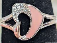 top view showing abstract design with CZ and pink enamel