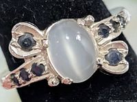 Front view of ring showing central cat's eye stone and onyx accents