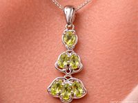 Front view of pendant on chain showing peridot arrangement