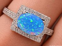 Front view of ring showing opalite cabochon and CZ halo