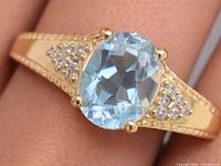 Top view of ring showing blue topaz and accent stones