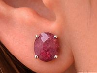 Earring worn in ear showing size and color of ruby