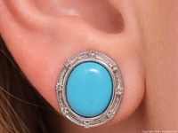 earring worn on ear showing size and design