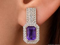 Earring worn on ear showing design, amethyst center, CZ halo