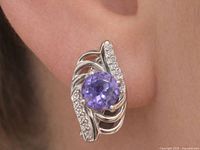 Earring shown on ear highlighting size, shape, amethyst centre and CZ accents