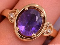 Front view of silver ring with oval amethyst and accent stones