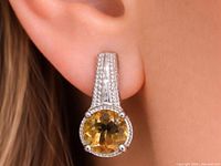 earring worn on ear showing smoky quartz and pavé accents