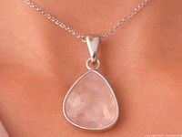 Pendant worn on chain showing size and color