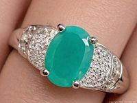 Top view of silver ring with green onyx and CZ accents