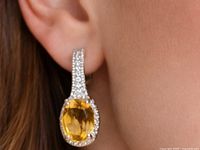 Earring worn on ear showing size and drop style