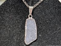 Close-up of druzy agate/quartz pendant on silver chain