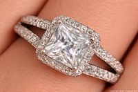 Ring on finger showing square-cut CZ, halo and split shank