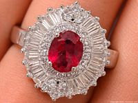Front view of ring on finger showing ruby centre and CZ halo