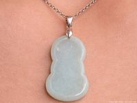 Jadeite pendant on neck, showing size and color