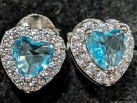 front view of both earrings showing blue heart stones and CZ halo
